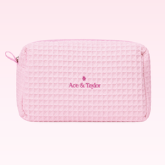 Roze gewafelde Ace & Taylor toilettas met geborduurd logo op roze achtergrond